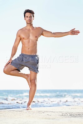 Buy stock photo Fitness, man and yoga tree pose on beach for exercise or stretching body in workout or training in nature. Fit, active or male yogi in warm up stretch, cardio or exercising in balance on ocean space