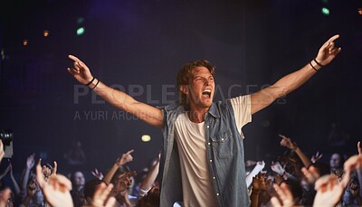 Buy stock photo An excited young man cheering atop a friend's shoulders as his favourite band plays
