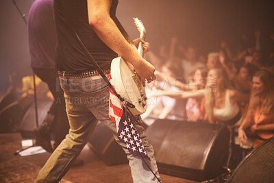 Buy stock photo Music festival, performer and playing guitar for entertainment, night and artist with musical instrument. Back, person and american flag for patriotism at concert, audience and crowd on usa stage