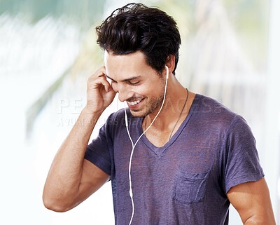 Buy stock photo Man, smile and listening with earphones for music, mental health podcast or radio. Male person, happy and streaming online with headphones for audio with fun, wellness and enjoyment with confidence