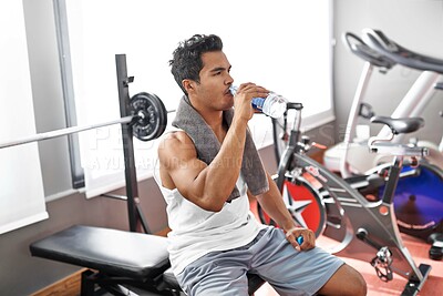 Buy stock photo Gym, fitness and man drinking water for training, wellness or exercise recovery, break or resting. Workout, hydration and thirsty male athlete with sports drink after intense, cardio or bodybuilding
