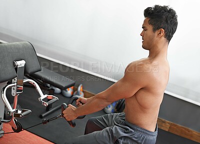 Buy stock photo Fitness, rowing machine and shirtless man in gym for health, wellness or bodybuilding workout. Exercise, strong and focus with body of young bodybuilder athlete training on equipment for improvement