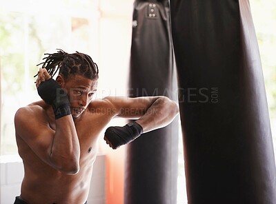 Buy stock photo Fitness, punching bag and black man in boxing gym for exercise, challenge or competition training. Power, muscle and serious champion boxer at workout with confidence, fight and energy in sports club