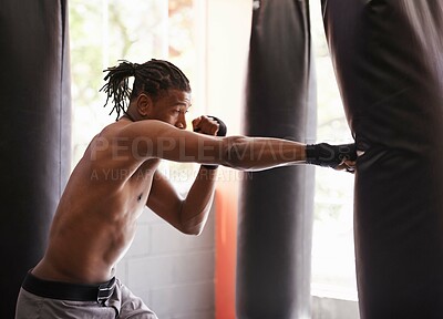 Buy stock photo Fitness, punching bag and black man in gym for exercise, boxing challenge or competition training. Power, muscle and serious champion boxer at workout with confidence, fight and energy in sports club