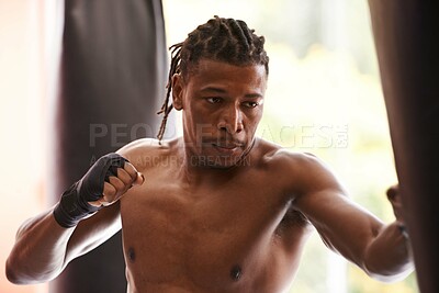 Buy stock photo Fitness, punching bag and serious black man in gym for exercise, boxing challenge or competition training. Power, muscle and champion boxer at workout with confidence, fight and energy in sports club