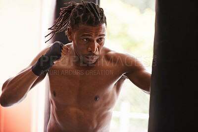 Buy stock photo Fitness, punching bag and black man in gym for fight, exercise or boxing competition training. Power, muscle and serious champion boxer at workout with confidence, challenge and energy in sports club