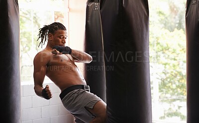 Buy stock photo Exercise, body and knee with black man kickboxing in gym for health, power or combat sports training. Fitness, club or self defense and young shirtless fighter with punching bag for strength workout