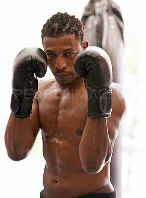 Buy stock photo Confidence, portrait and black man with boxing gloves in gym for challenge, fight and competition training. Power, muscle and serious face of champion boxer at workout with fitness in sports club.