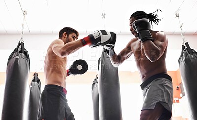 Buy stock photo Men, boxer and training competition with gloves in gym or endurance practice for champion, challenge or fighting. Male people, opponents and punch for battle sport with muscle action, exercise or fit