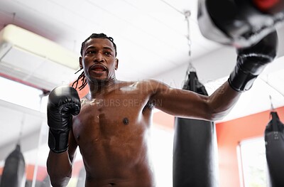 Buy stock photo Man, boxing and bag with gloves for fitness or strong practice or fight competition, training or challenge. Black person, sweat and gym workout or exercise in Nigeria or confident, muscle or combat