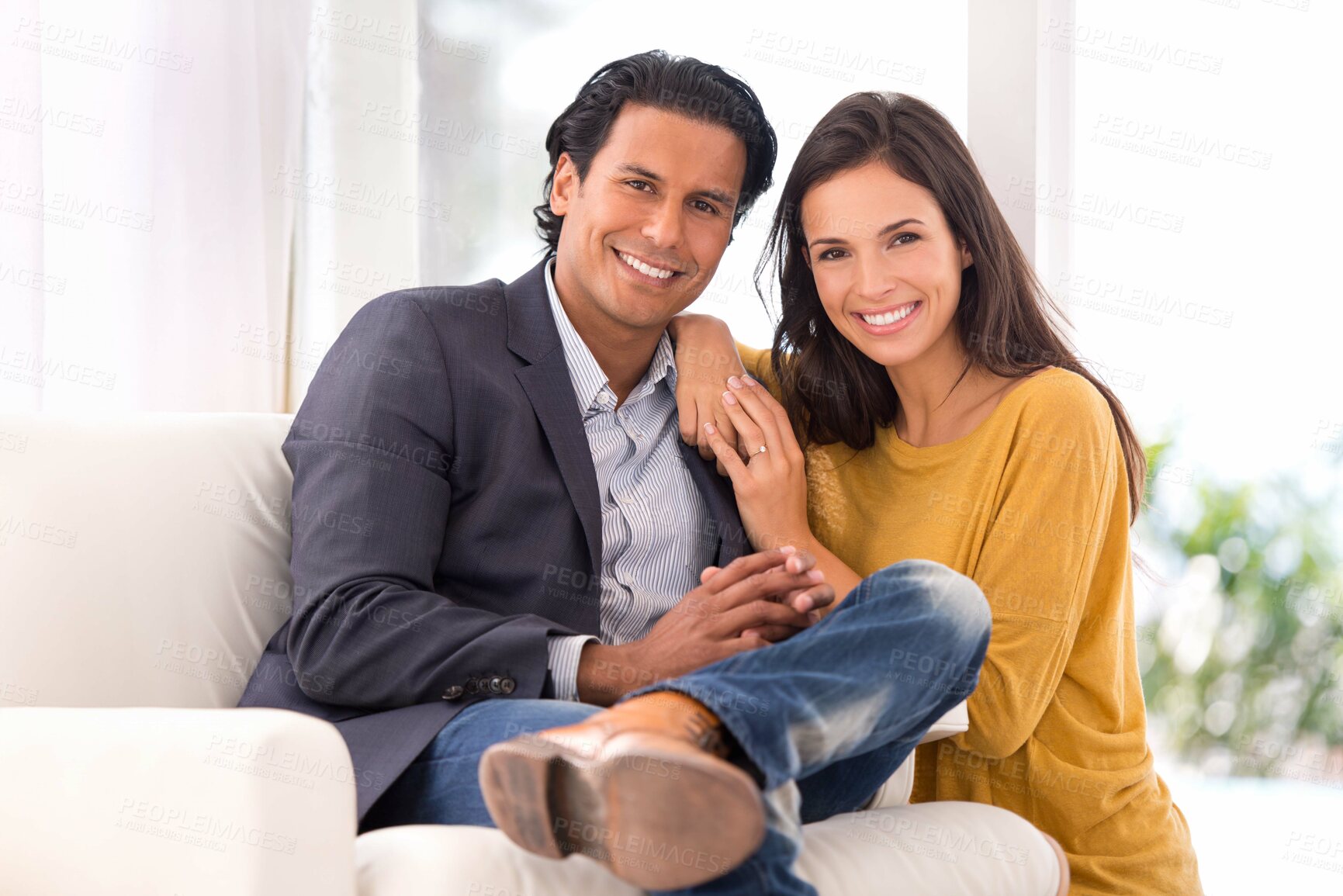 Buy stock photo Smile, love and couple on chair in living room at home with comfortable romance and care. Happy, marriage and portrait of young man and woman sitting on sofa together in lounge at modern house.