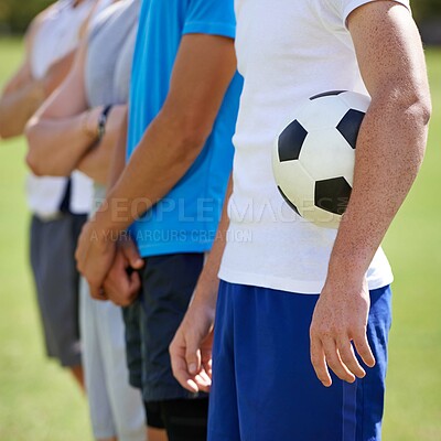 Buy stock photo Field, team and hand holding soccer ball for game, training and competition with fitness. People, group and football player with anthem, captain or leader for sports, exercise or workout for contest