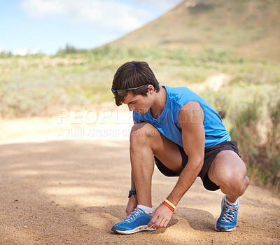 Buy stock photo Tie, running or man with shoe lace for fitness training, walking exercise or workout on path or sand. Runner, wellness or male sports athlete with footwear ready to start outdoor cardio in nature