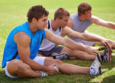 Buy stock photo Group, men and grass for stretching legs on ground for warm up, workout and training together in nature. Sports, people and exercise on lawn for health, wellness and fitness on field with friends