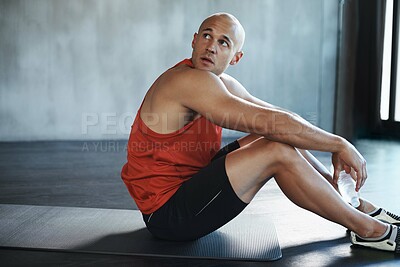 Buy stock photo Workout, looking and man relax on floor after health club exercise, sports commitment or gym training. Tired breathing, thinking man and healthy person sitting after cardio, fitness or challenge