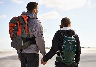 Buy stock photo Travel, backpack or couple in desert holding hands for adventure, journey or resort, location or explore. Freedom, love or back of people in Egypt for sand dunes walking, wellness or hiking in nature