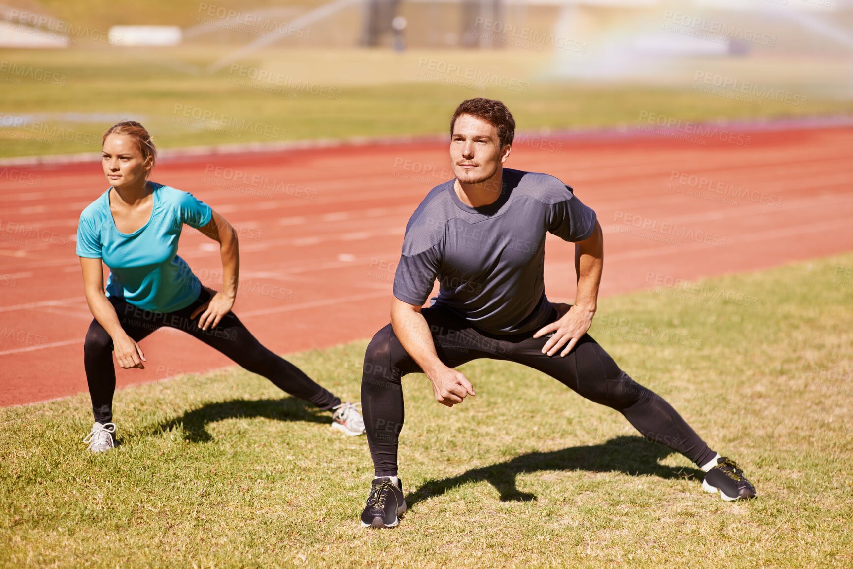 Buy stock photo Sports, legs and people stretching at stadium for race, marathon or competition training for health. Fitness, energy and couple athletes with warm up exercise for running cardio workout on track.