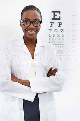 Buy stock photo Portrait of a female optometrist standing beside a eye test chart