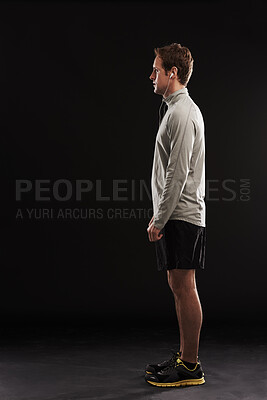 Buy stock photo Space, profile or runner in studio for fitness, running workout or exercise for health, body or mockup. Black background, athlete or side view of sports man ready to start training in music earphones