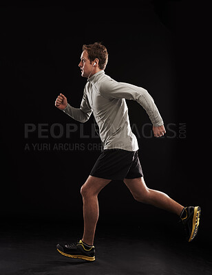 Buy stock photo Man, music or fitness in studio with running for exercise, marathon or workout with earphones. Athlete, person or cardio for healthy body, wellness or training with radio or audio on black background