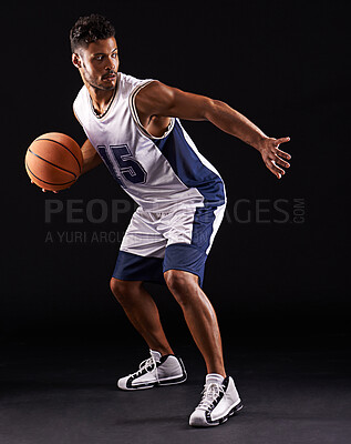 Buy stock photo Man, sport and basketball player in studio for fitness, competition and training on black background. Professional athlete, career and exercise with ball for game, hobby and healthy model in action