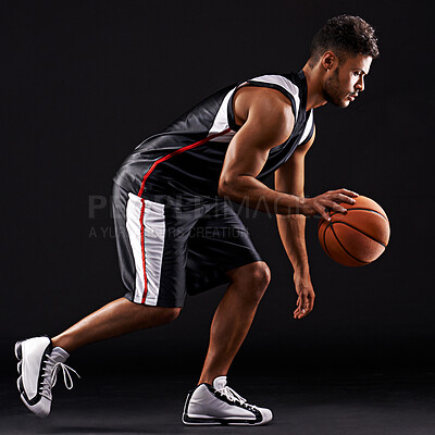 Buy stock photo Man, basketball player and playing sport in studio for workout training, black background or mockup space. Male person, running and healthy performance for exercise wellness, practice or professional
