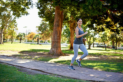 Buy stock photo Happy woman, running and training in portrait in park, music and streaming audio for exercise in nature. Athlete, smile face and wellness with headphones for fitness and runner in outdoor in montreal