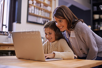 Buy stock photo Mama, child and learning with laptop for support, care or browsing in the kitchen at home. Mother, daughter or kid typing on computer for social media, reading or helping girl on project or homework