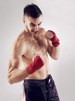 Buy stock photo Fist, MMA and angry male fighter for martial arts pose, boxing and mad expression on white background. Wraps, hands and athlete for exercise and man kickboxer, studio and training for impact sports