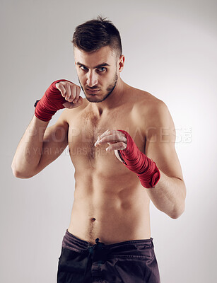 Buy stock photo Fist, MMA and portrait of male fighter for martial arts, boxing and angry on white background. Hands, athlete and exercise for man kickboxer, studio and training for impact sports competition 