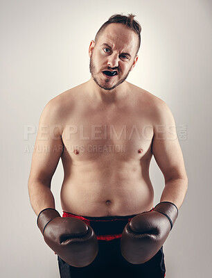 Buy stock photo Sports, serious man and portrait of boxer for fitness in studio isolated on a white background with tattoo. Body, strong athlete and fighter in gloves with attitude for exercise, workout or challenge