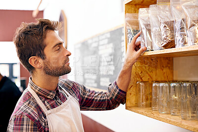 Buy stock photo Man, barista and check by shelf in a coffee shop with idea for service, search or ingredients for drink. Waiter, person or small business owner in a cafe with product, beans and thinking for decision