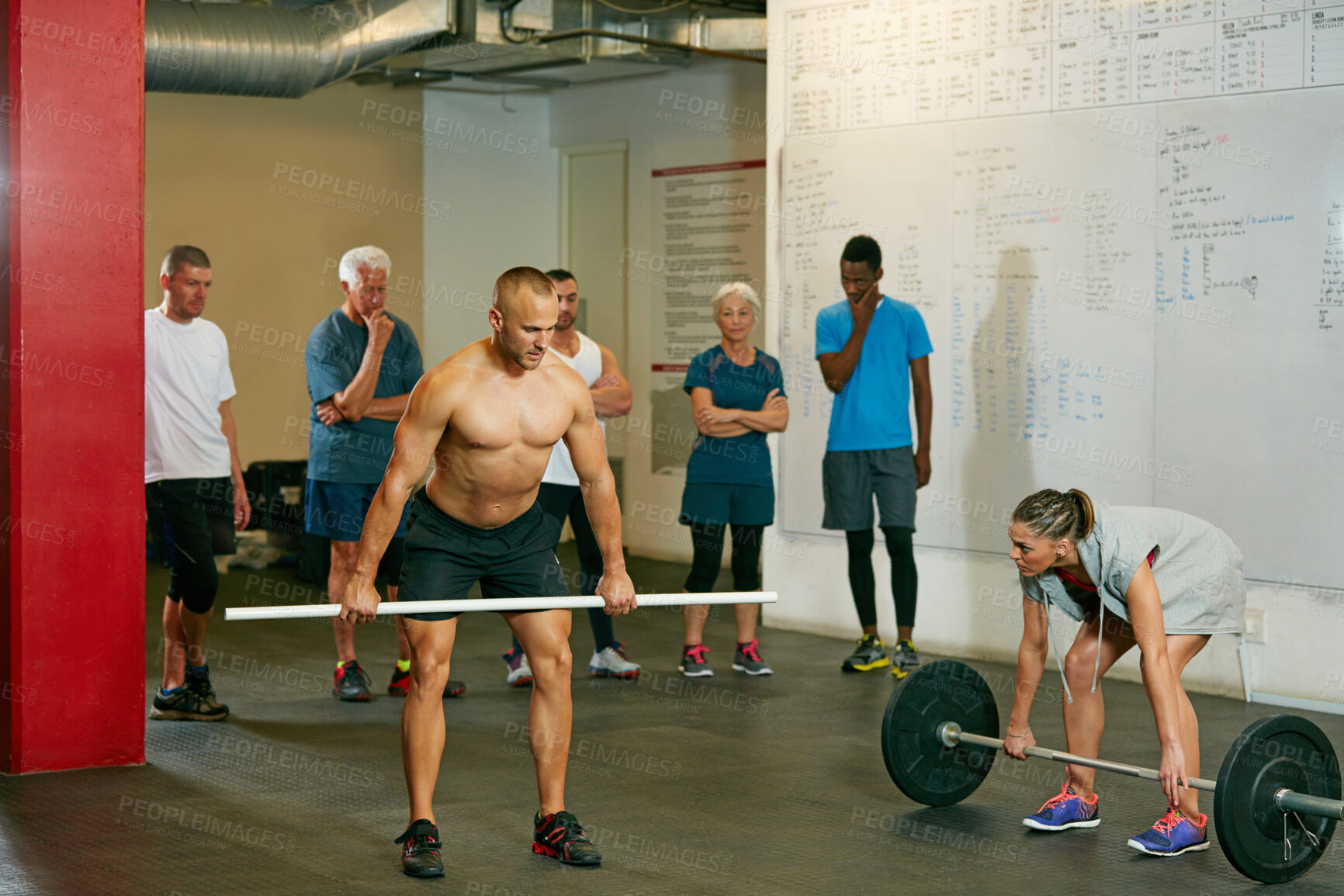 Buy stock photo Shot of a fitness group working out at the gym