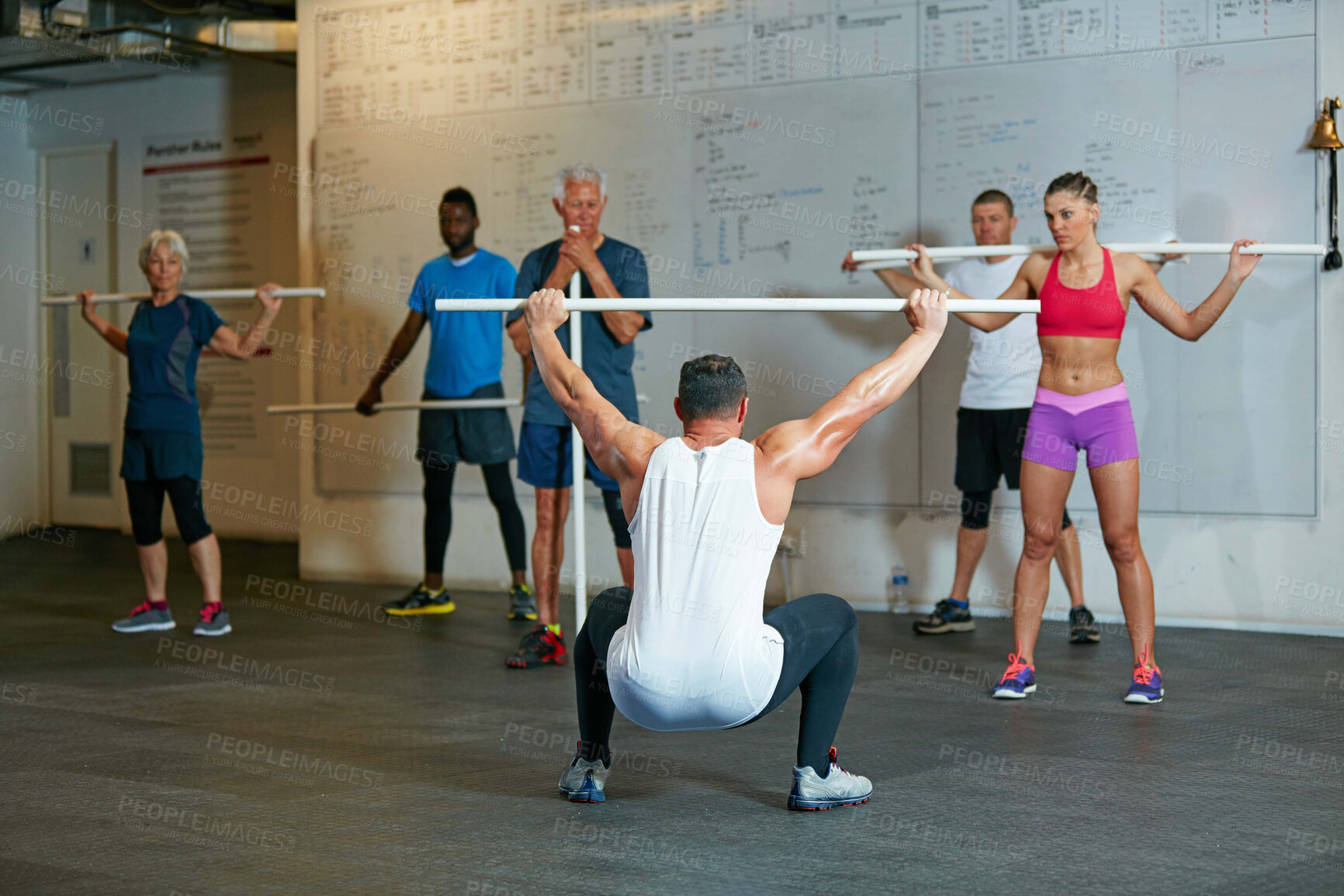 Buy stock photo Shot of a fitness group working out at the gym