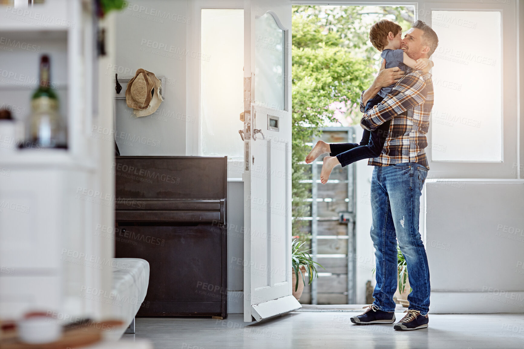 Buy stock photo Happy family, love and father hug son, happy and excited to return home, hello and bond. Happy family, greeting and child embrace parent at front door, coming home and content, happiness and playful