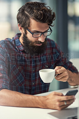 Buy stock photo Man, phone and coffee in office for agency with online connection, social media and web design software. Male designer, drink and mobile app in workplace with tattoo, wordpress and wifi for talking