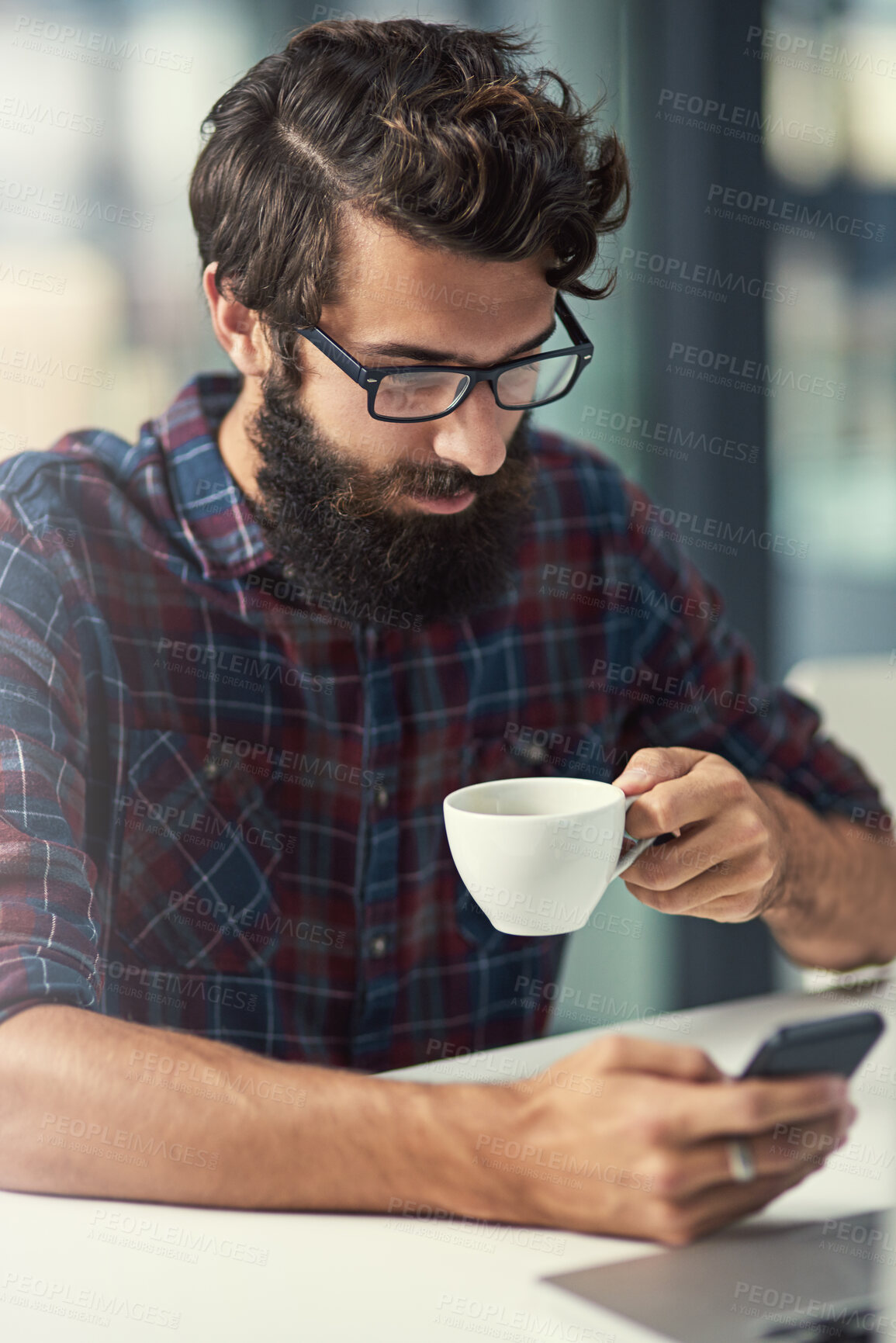 Buy stock photo Man, phone and coffee in office for agency with online connection, social media and web design software. Male designer, drink and mobile app in workplace with tattoo, wordpress and wifi for talking