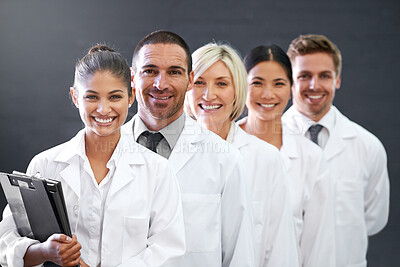 Buy stock photo Smile, portrait and row of doctors in studio for health insurance, medicine and trust in hospital. Confidence, group and diversity with men, women and professional medical team on grey background
