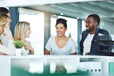 Buy stock photo Group of business people talking and having a friendly discussion at work. Happy smiling employees telling funny stories. Diverse team laughing and sharing ideas in an informal brainstorming session.