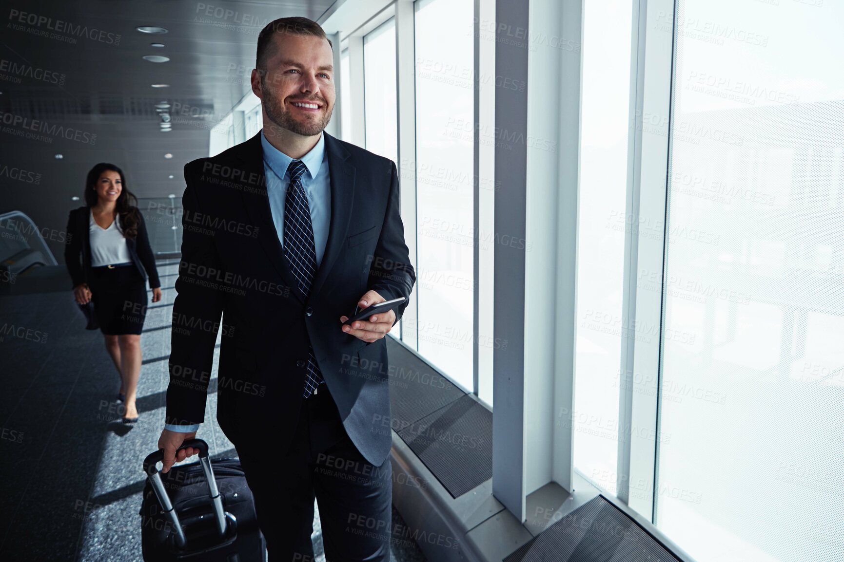 Buy stock photo Business man, smartphone and travel by airport window for reading, thinking and contact in corridor with smile. Entrepreneur, luggage and phone for flight schedule and global immigration in London