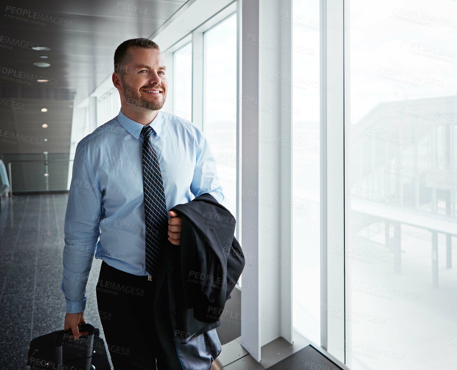 Buy stock photo Walking, hall or man in airport for company trip with suitcase or luggage for commute or vacation. Happy businessman, smile or corporate worker in lobby for journey, flight or international travel 