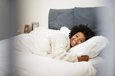 Buy stock photo African, woman relax and bed in home, blanket and comfort on weekend morning for rest and wellness. Happy, smile and awake feeling positive or calm and peace, lazy Sunday and bedroom in apartment
