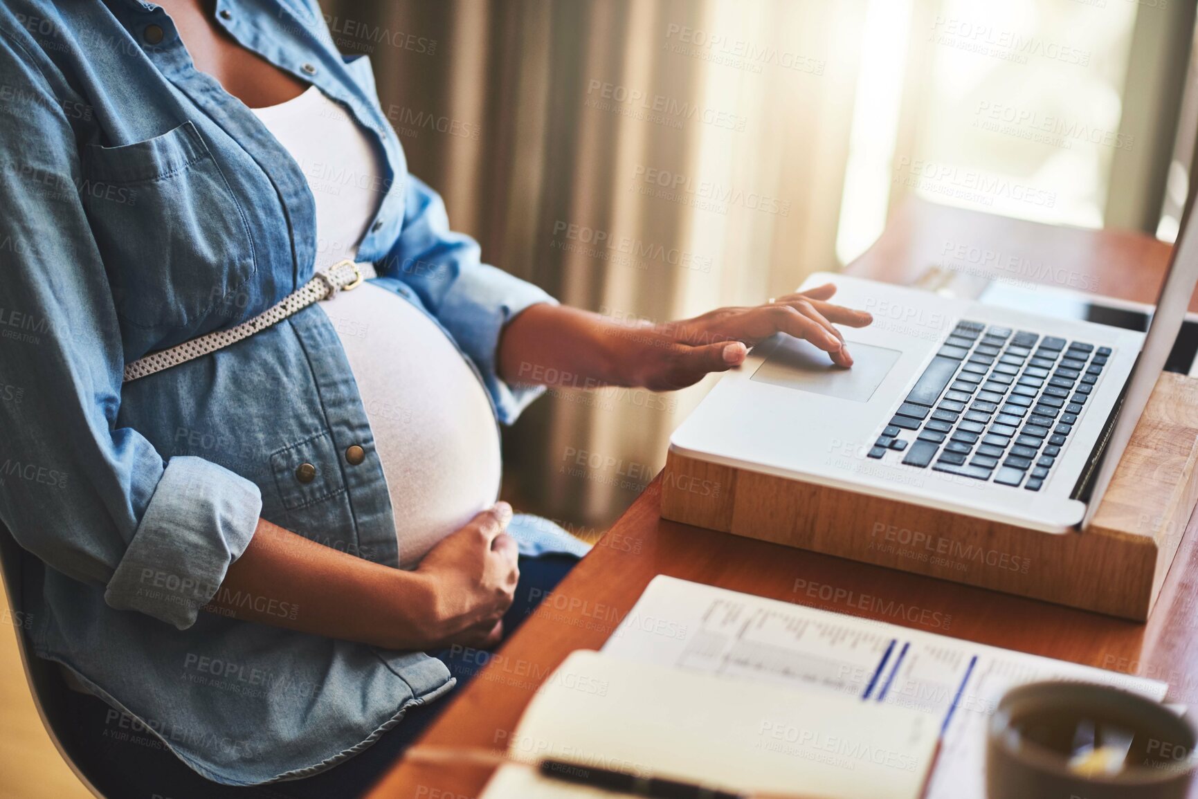 Buy stock photo Cropped shot of a pregnant woman using a laptop while working from home