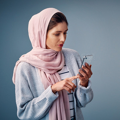Buy stock photo Muslim, girl and typing online with phone to search for Palestine, news and reading post on web. Contact, communication and woman scroll social media on smartphone in studio background or mockup