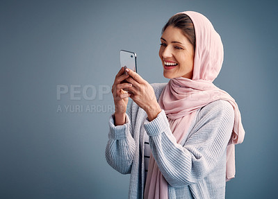 Buy stock photo Muslim, woman and online with phone on social media live stream and post feedback on web. Contact, communication and girl chat on internet with network on smartphone in studio background or mockup