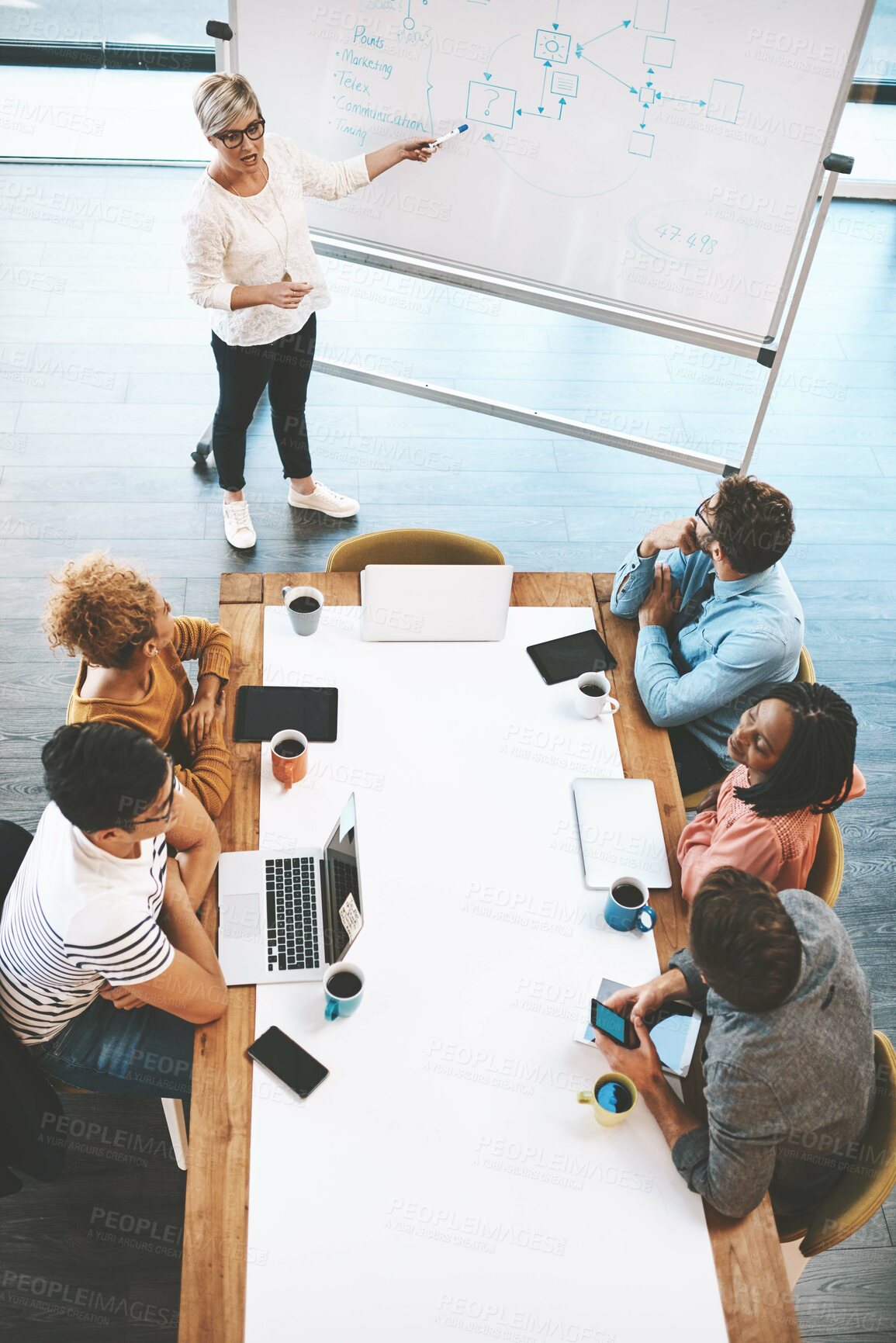 Buy stock photo Presentation, female leadership and innovation during meeting with marketing team in creative office. Above coworkers planning new strategies while sharing vision and mission for a startup business 