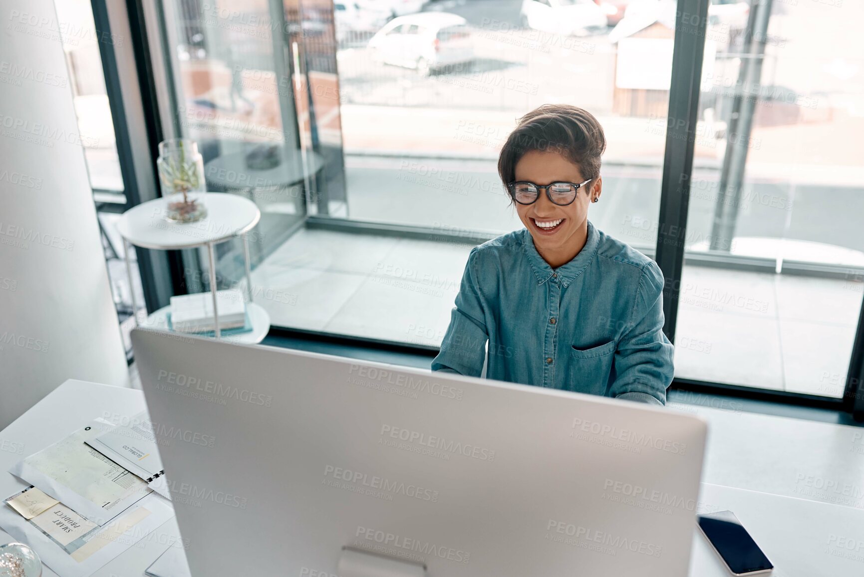 Buy stock photo Cropped shot of an attractive young businesswoman sitting alone and working on her computer in the office