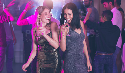 Buy stock photo Shot of two young women dancing in a nightclub