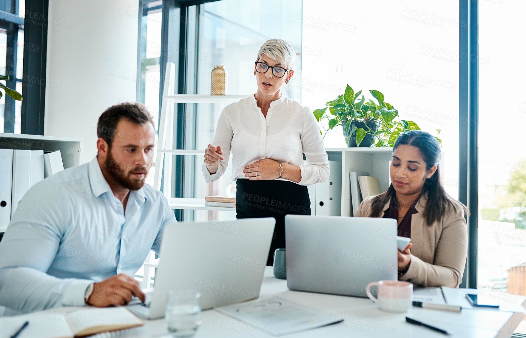 Buy stock photo Shot of a group of businesspeople working together in an office