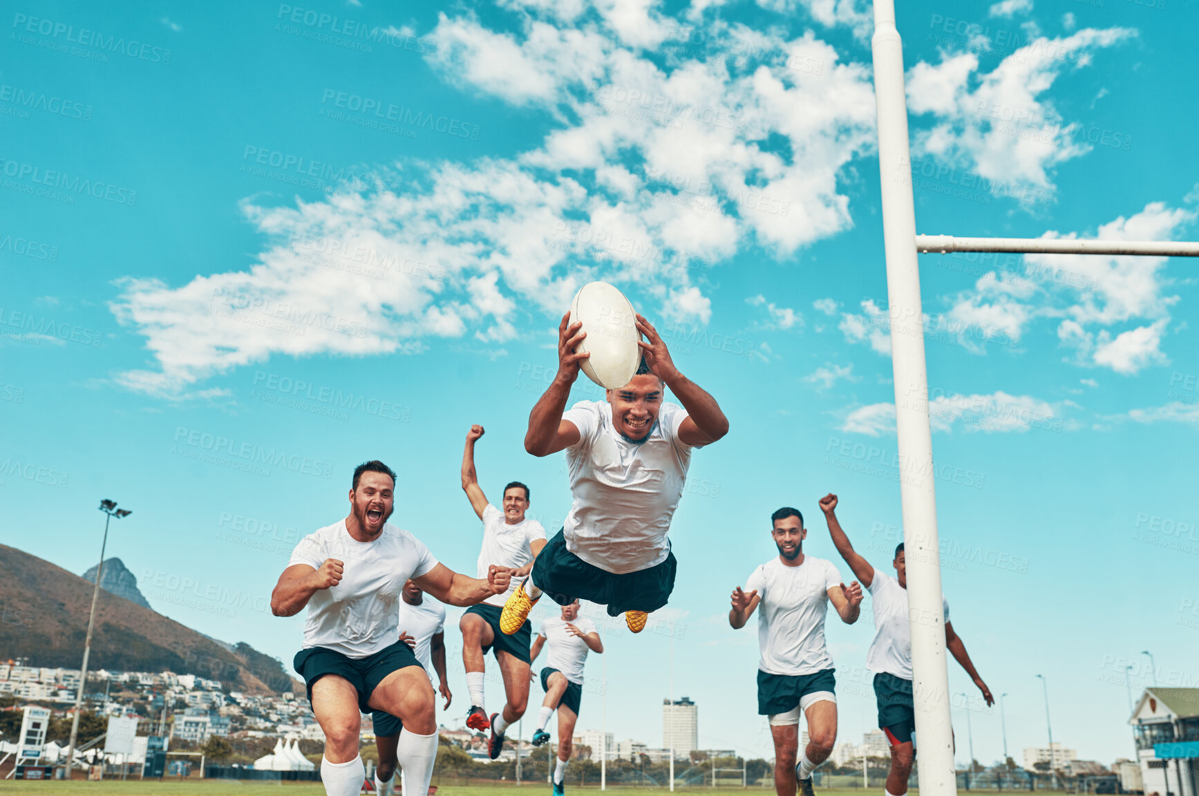 Buy stock photo Shot of a rugby player scoring a try while playing on a field